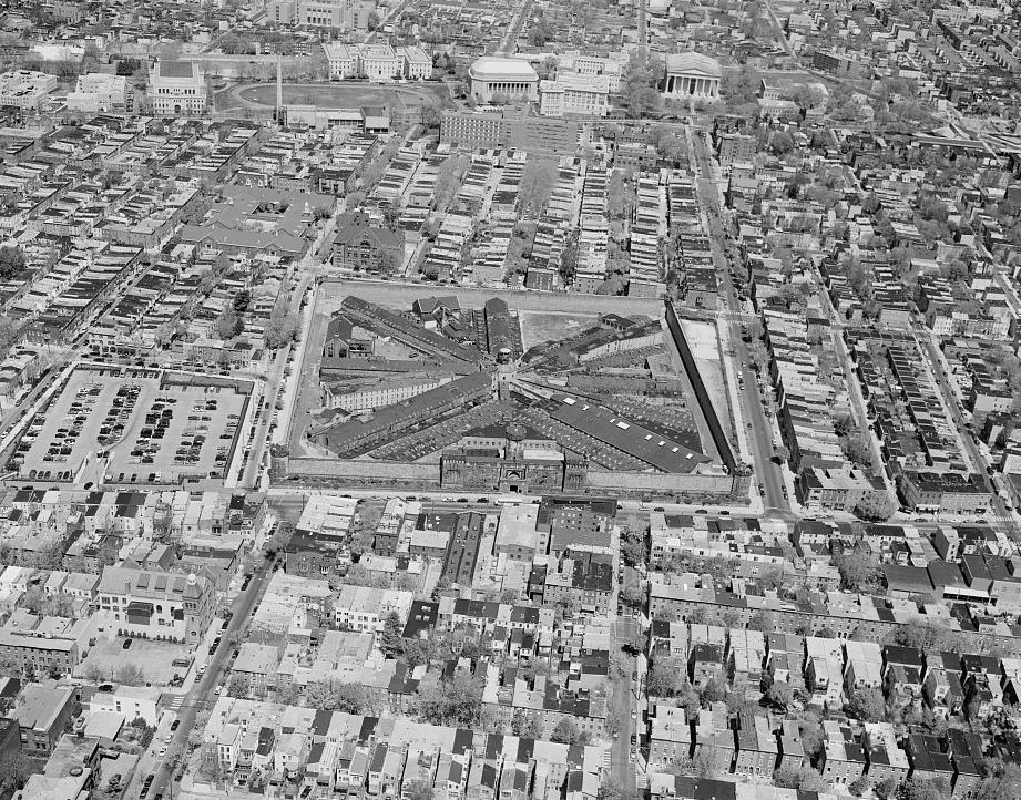 Eastern State Penitentiary, Philadelphia Pennsylvania AERIAL VIEW, LOOKING NORTH. THE STRUCTURES WITHIN THE WALLED PRECINCT ONE BLOCK TO THE NORTH OF THE PENITENTIARY (ALONG THE TOP OF THE PHOTOGRAPH) COMPRISE GIRARD COLLEGE. ESTABLISHED IN 1833 UPON THE DEATH OF STEPHEN GIRARD, THE PRECINCT WALL AND ORIGINAL BUILDINGS WERE CONSTRUCTED BETWEEN 1833 AND 1848 ON DESIGNS BY WILLIAM STRICKLAND, WHICH WERE CONCEIVED WITHIN PARAMETERS SET BY GIRARD&#146;S WILL. THE SCHOOL IS STILL USED FOR ITS INTENDED EDUCATIONAL FUNCTION (2003)