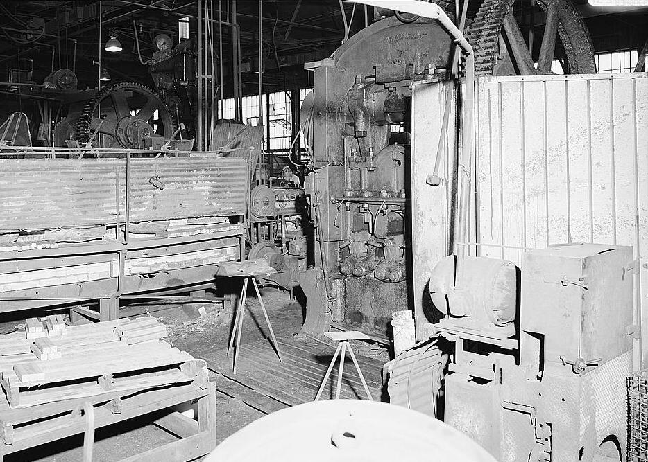 Warwood Tool Company, Wheeling West Virginia INTERIOR VIEW OF EYE PRESS AREA; TO LEFT IS A TWO-BAY SLOTTED TYPE FURNACE, TO CENTER IS EYE PRESS, TO RIGHT IS CURCULAR SAW 1990
